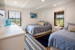 Bedroom with two double beds, dresser and night stand